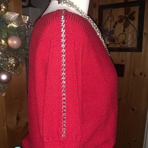 Jennifer Lopez sweater with chain detail down sleeve.